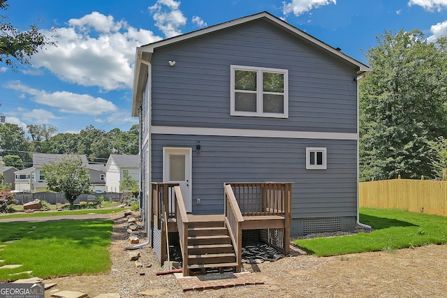 back of house featuring a yard and a deck