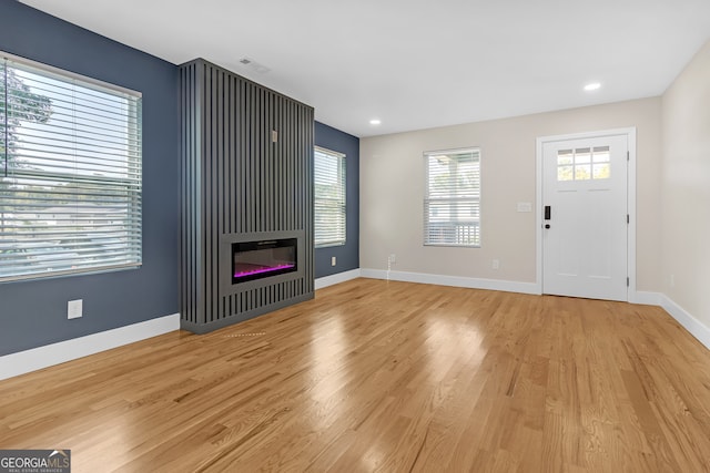 unfurnished living room featuring light wood-type flooring