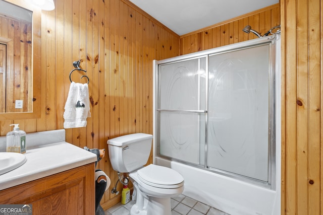 full bathroom featuring enclosed tub / shower combo, wooden walls, vanity, and toilet