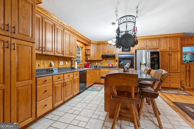 kitchen with light tile patterned flooring, ventilation hood, sink, and black appliances