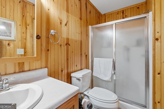 bathroom with wood walls, vanity, walk in shower, and toilet