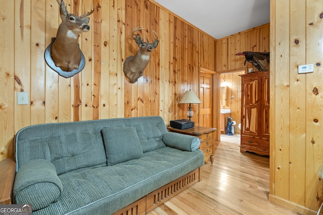 living room featuring wooden walls and light hardwood / wood-style floors