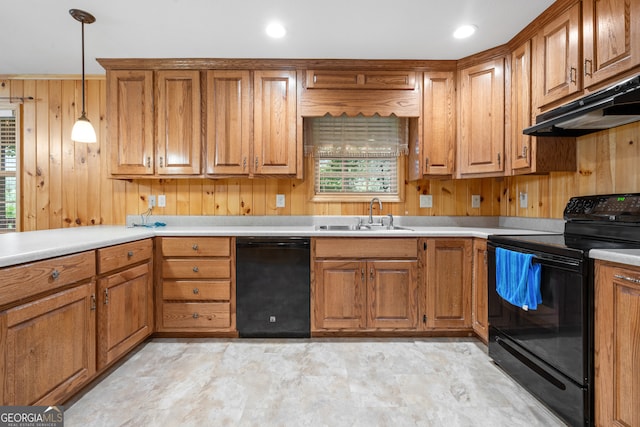 kitchen with sink, black appliances, light tile patterned floors, and a wealth of natural light