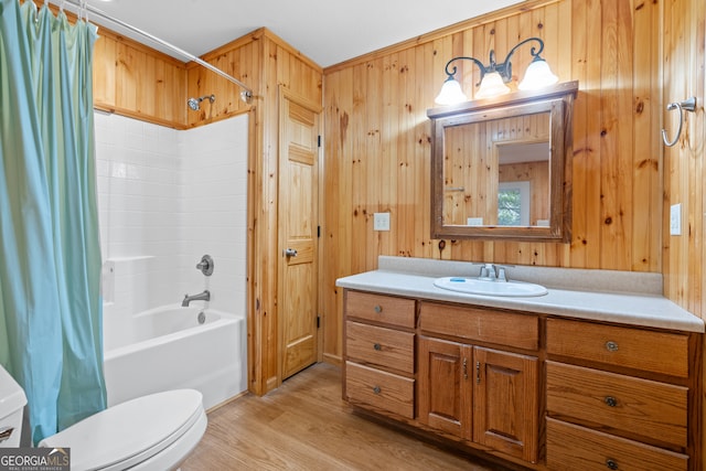 full bathroom featuring wood walls, toilet, vanity, and wood-type flooring