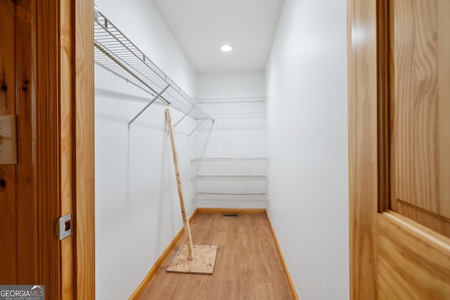 spacious closet featuring light hardwood / wood-style flooring