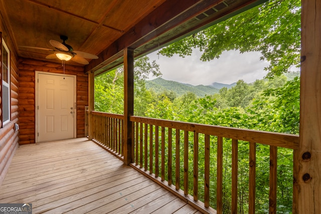 deck with a mountain view and ceiling fan