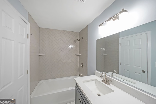 bathroom with vanity and tiled shower / bath combo