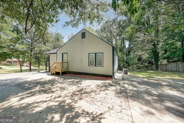 rear view of house featuring central air condition unit