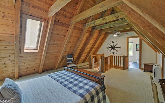 bedroom with light colored carpet, vaulted ceiling with skylight, and wooden ceiling