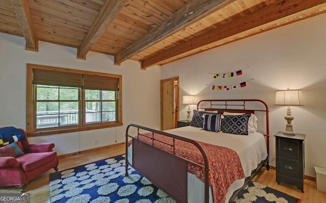 bedroom featuring wooden ceiling, beamed ceiling, and light wood-type flooring