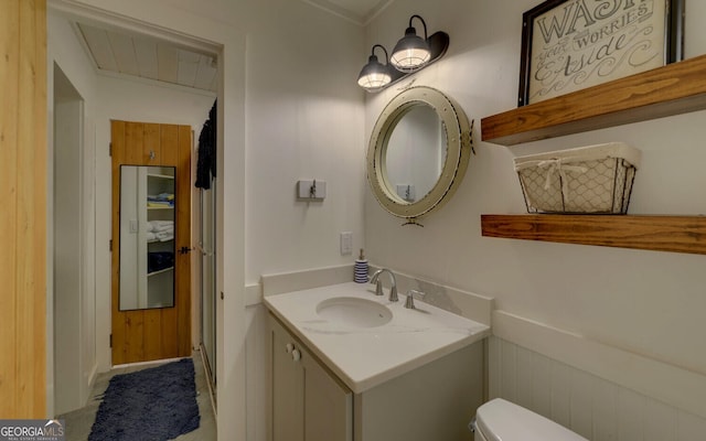 bathroom featuring vanity and toilet