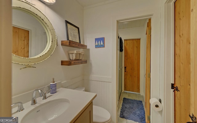 bathroom with toilet, tile patterned flooring, and vanity