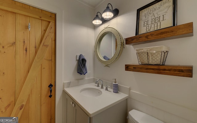 bathroom featuring vanity and toilet