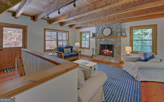 living room featuring a fireplace, beam ceiling, wooden ceiling, and wood-type flooring