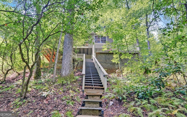 back of house featuring a deck