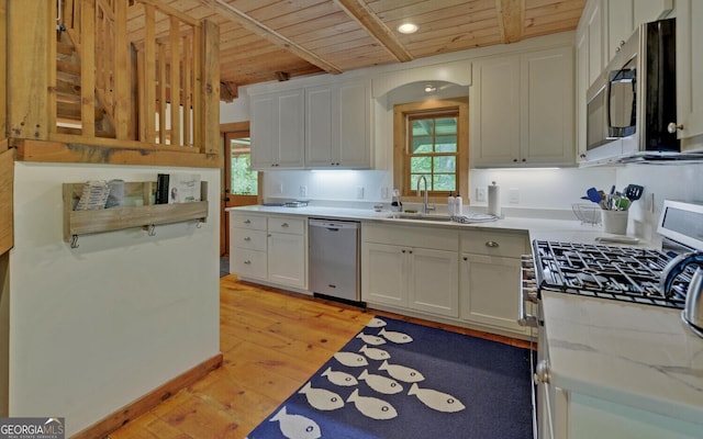 kitchen with white cabinets, stainless steel appliances, light hardwood / wood-style flooring, and wood ceiling