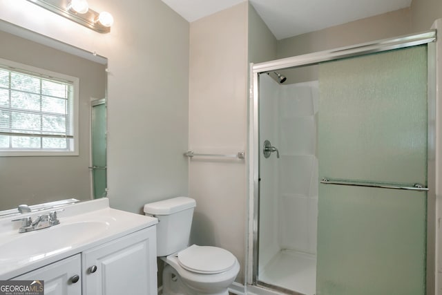 bathroom with an enclosed shower, toilet, and vanity