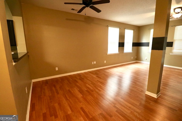 spare room featuring ceiling fan and hardwood / wood-style floors