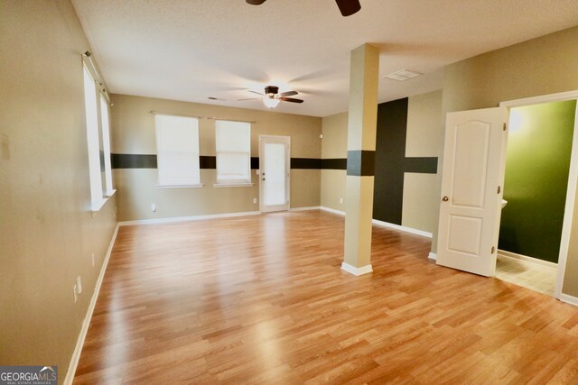 empty room featuring ceiling fan and light hardwood / wood-style floors