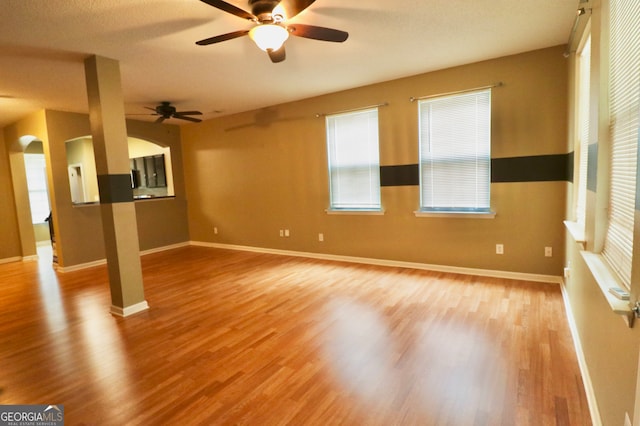 unfurnished room with ceiling fan and light wood-type flooring