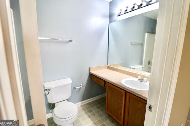 bathroom with tile patterned flooring, toilet, and vanity