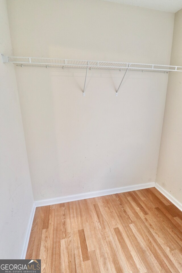 walk in closet featuring hardwood / wood-style floors