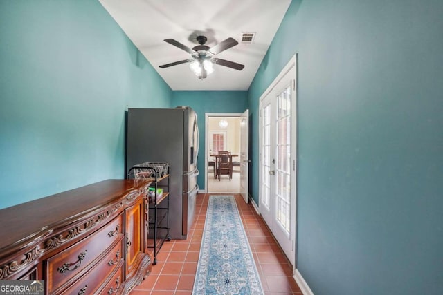 hall with french doors and light tile patterned floors