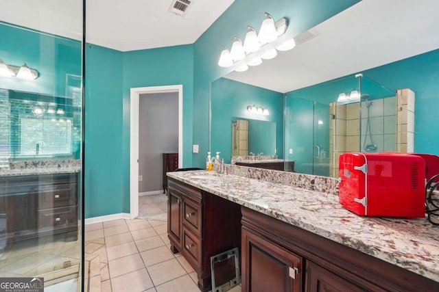 bathroom with vanity, walk in shower, and tile patterned floors