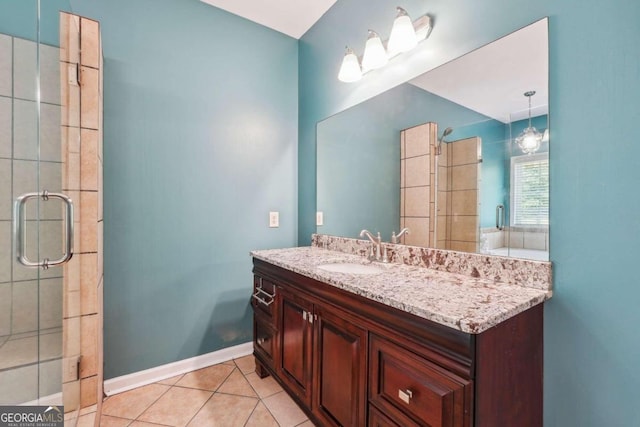 bathroom with an enclosed shower, vanity, and tile patterned flooring