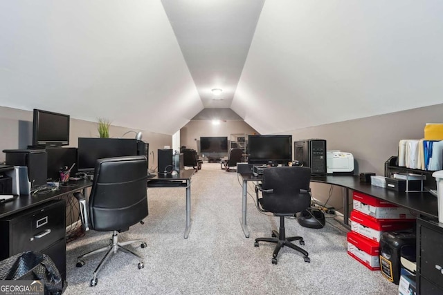 carpeted office featuring vaulted ceiling