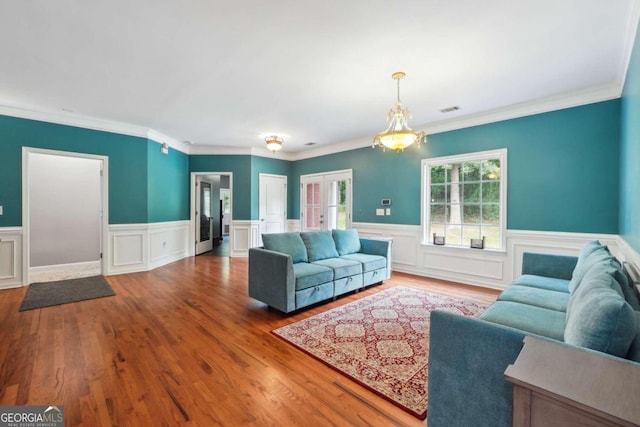 living room with crown molding and hardwood / wood-style flooring