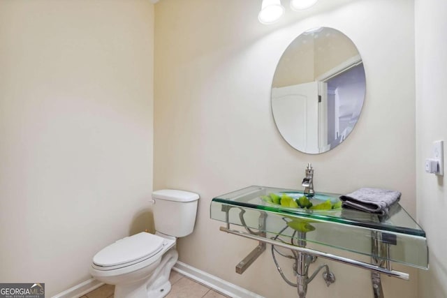 bathroom featuring toilet and tile patterned flooring