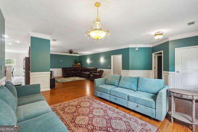 living room featuring ornamental molding and light hardwood / wood-style floors