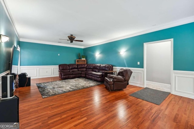 living room with ceiling fan, hardwood / wood-style floors, and ornamental molding