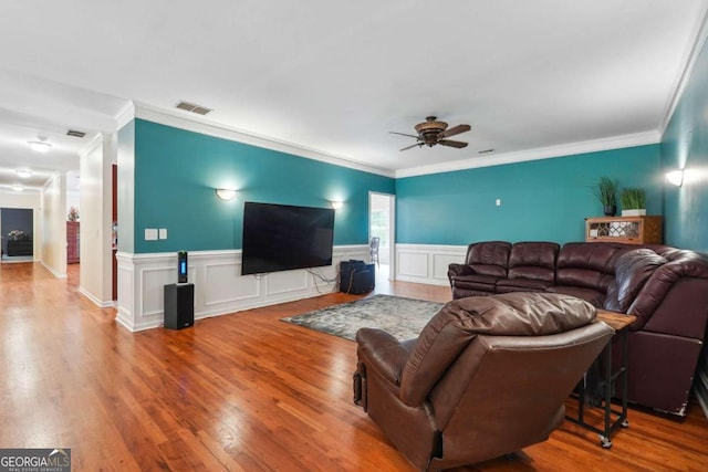 living room featuring ceiling fan, hardwood / wood-style floors, and ornamental molding