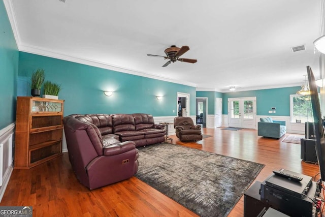 living room featuring hardwood / wood-style flooring, french doors, ceiling fan, and crown molding