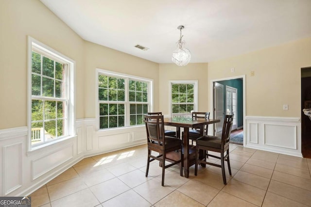 dining space with an inviting chandelier and light tile patterned floors