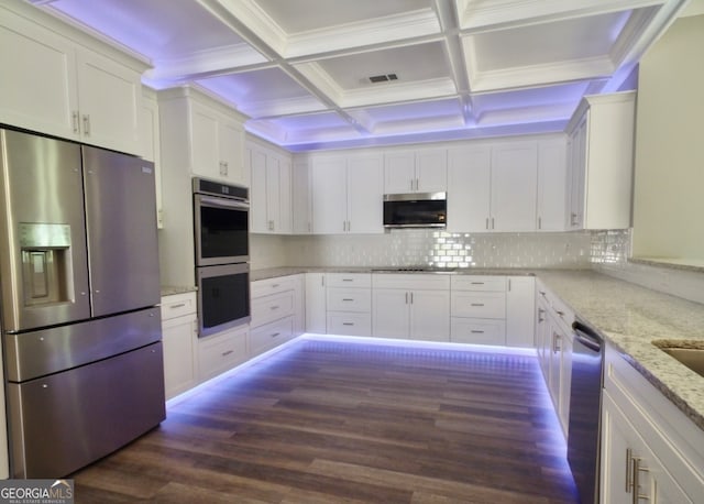 kitchen with appliances with stainless steel finishes, dark hardwood / wood-style floors, coffered ceiling, tasteful backsplash, and white cabinetry