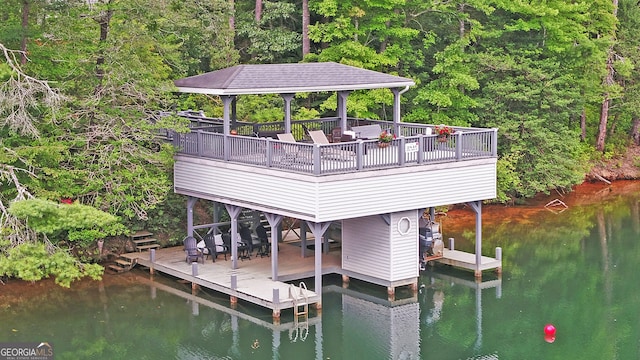 dock area featuring a deck with water view and a gazebo