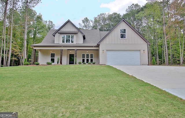 view of front of property with a front lawn, covered porch, and a garage