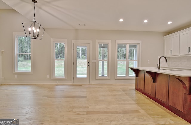 kitchen featuring decorative light fixtures, plenty of natural light, sink, and a chandelier