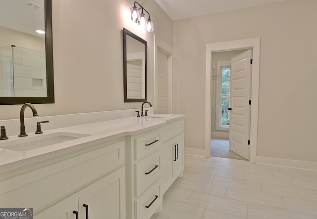 bathroom featuring walk in shower and vanity