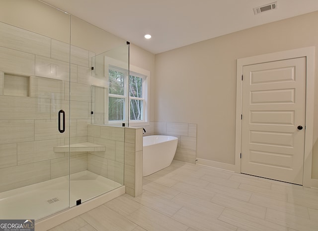 bathroom featuring plus walk in shower