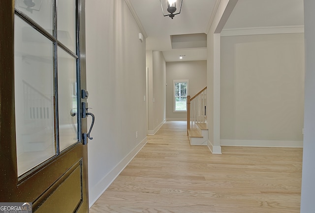 entryway featuring light hardwood / wood-style flooring and crown molding