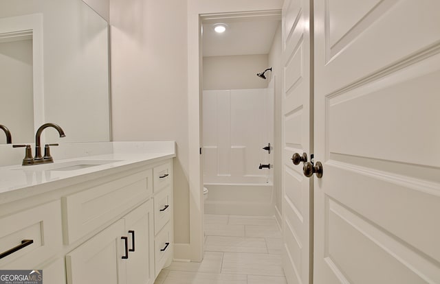 full bathroom with shower / tub combination, vanity, tile patterned flooring, and toilet