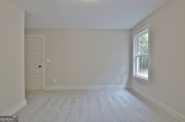 unfurnished room with light carpet and a wealth of natural light