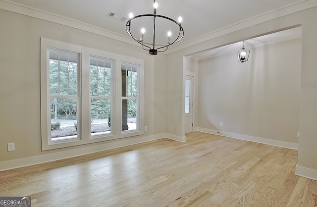 unfurnished room with an inviting chandelier, light hardwood / wood-style flooring, plenty of natural light, and ornamental molding