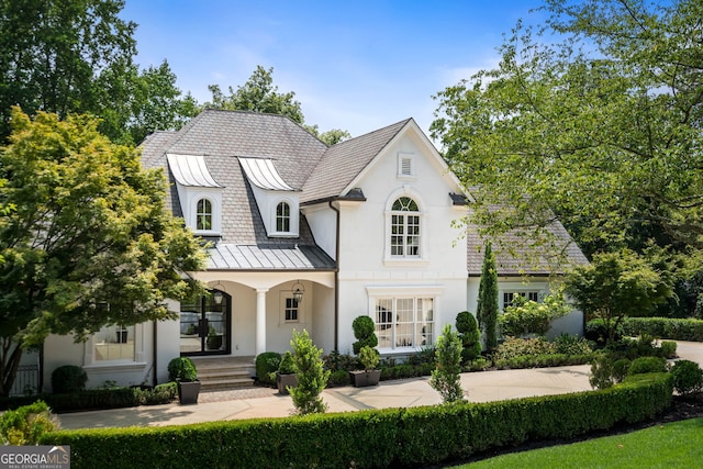 french provincial home featuring a porch