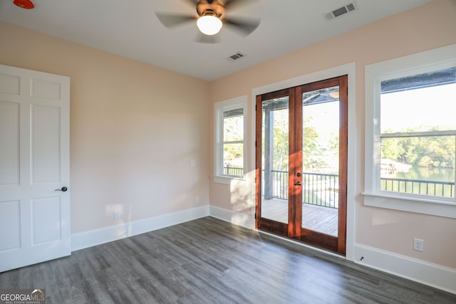 interior space featuring dark wood-type flooring, ceiling fan, and french doors