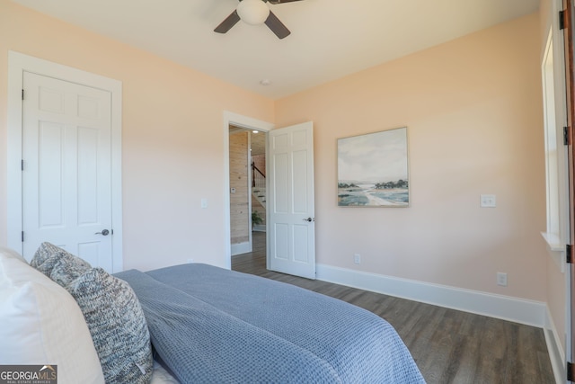 bedroom with ceiling fan, baseboards, and wood finished floors